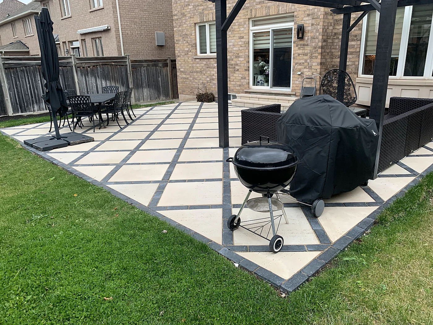 Completed backyard patio and outdoor living space by XY Landscaping